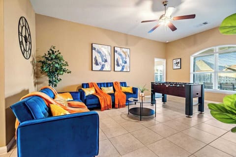 Bright Crowley living room with comfortable seating, TV and foosball—an inviting place for construction crews, contractors, insurance housing guests and extended-stay families to relax, stream and recharge after a busy workday.