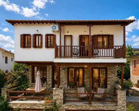 Property Exterior: charming traditional stone and timber villa with spacious balconies and outdoor seating areas.