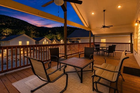 A warm, inviting porch with sunset views showcases classic New Braunfels river‑home charm near the Guadalupe River.