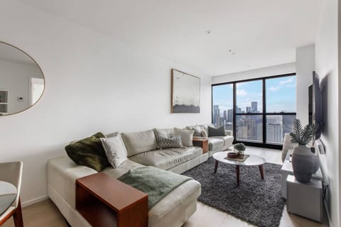After a day discovering Melbourne, retreat to the light-filled living area where plush sofas, sweeping skyline views, central climate control, and a wall-mounted TV create the perfect setting for a relaxed night in.