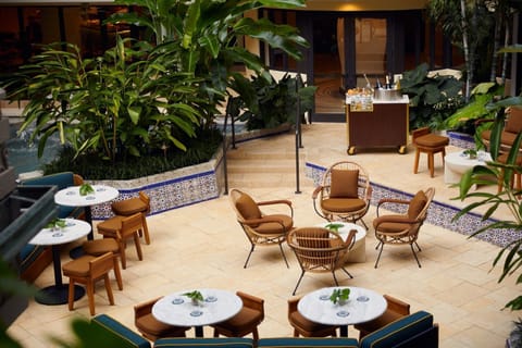 Unwind at the fountain lounge, where the sound of water complements a drink among tropical plantings