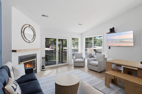 Bright living room with fireplace, patio access, and relaxing seating