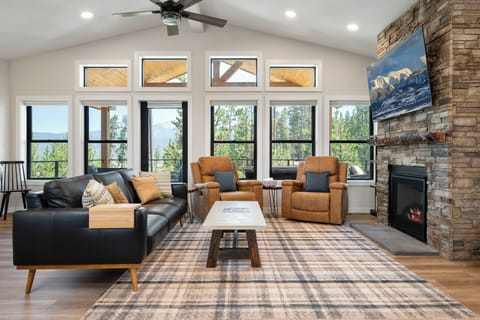 Main Floor Living Room with Gas Fireplace and 65" Smart TV
