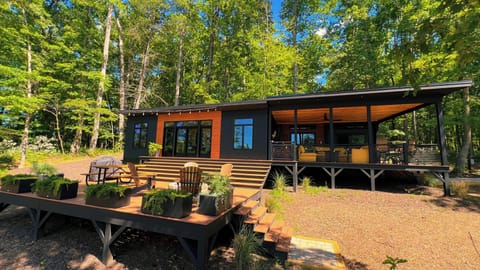 Modern forest cabin with spacious decks and a serene covered porch