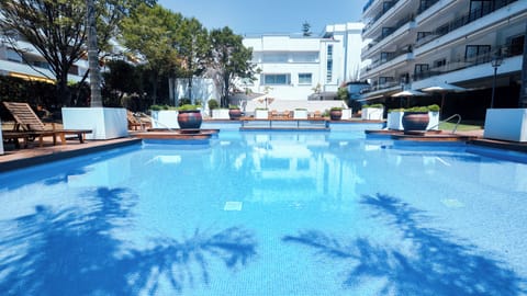 Seasonal outdoor pool, open 9:00 AM to 10:00 PM, pool umbrellas
