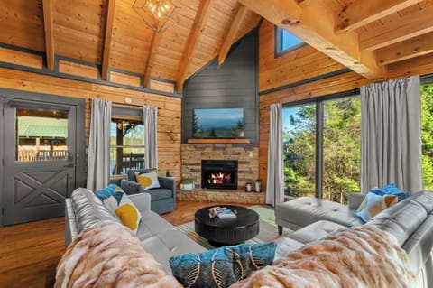 The heart of Falcon Ridge Retreat. Gather around the fireplace, take in the soaring ceilings and mountain views, and make unforgettable memories together.