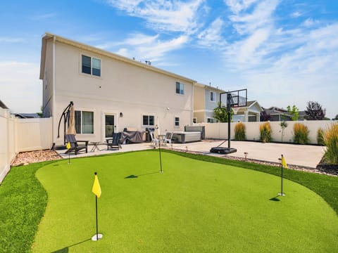 A spectacular outdoor recreation feature that brings luxury resort-style living to the backyard. Manicured artificial turf with championship-quality putting surfaces provides endless entertainment for golf enthusiasts of all skill levels. Multiple holes create an engaging experience while the nearby seating allows spectators to enjoy the fun.