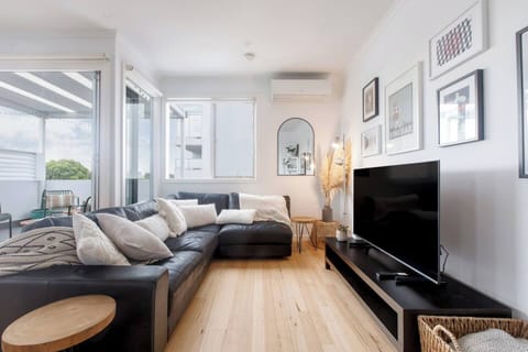 he lounge and dining space opens to a covered balcony, creating a lovely transition between the indoors and out.
