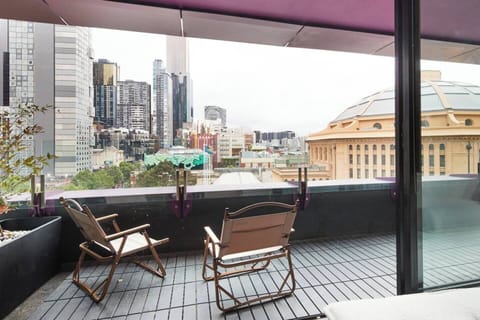 Take in views stretching over the city skyline from your private balcony, a true urban oasis.
