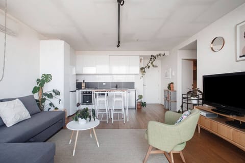 The living area evokes a calming vibe, brimming with greenery and natural light.  
