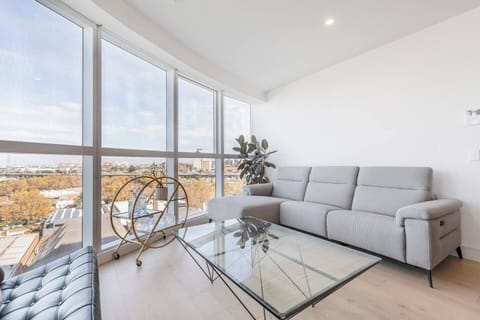 A second living space next to the dining area is complete with a sofa and sweeping views of the city and surrounding parklands.

