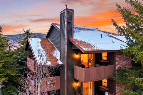 Exterior view of the building at dusk with lights on.