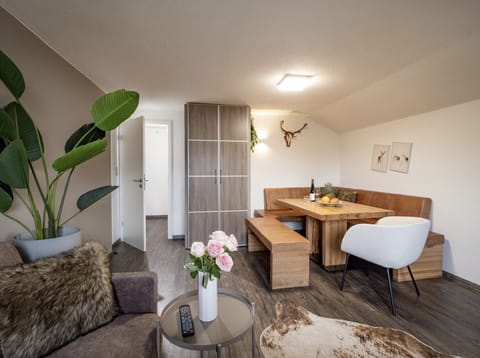 Westendorf vacation rental for up to 5 guests with living room, dining area, balcony access and a quiet base near SkiWelt, ski bus and Alpine trails.