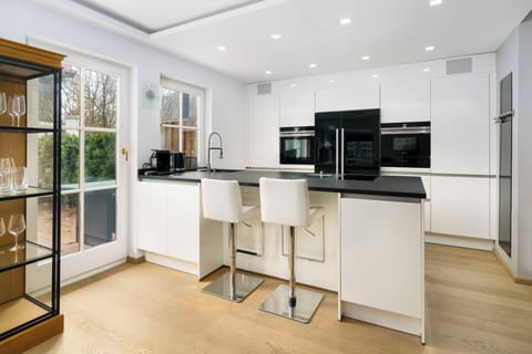 Book an upscale Kitzbühel vacation apartment with modern designer kitchen, island, patio and location near old town, Ganslernhang and Streif.
