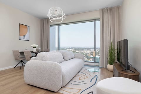 Relax in the stylish living room with a comfortable sofa and modern decor.