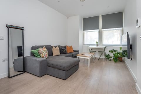 Stylish lounge area with full-length mirror, sofa seating and workspace