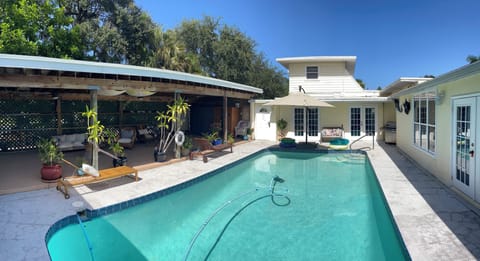 Looking toward the front house from the courtyard. Shows pool, patio and sauna