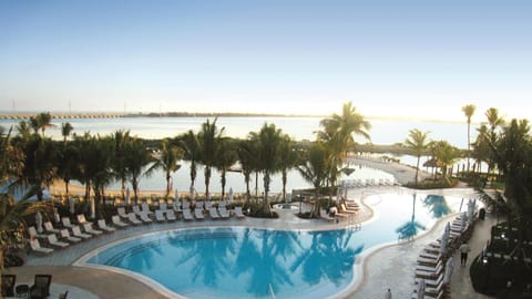 Gather by the glowing fire as the pool shimmers nearby.