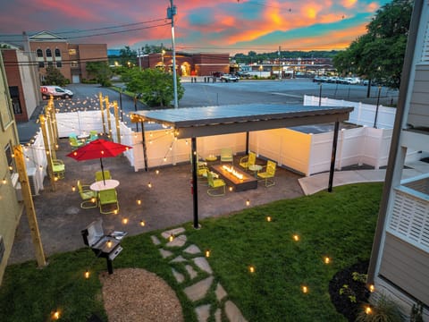 Charming lit courtyard with fire pit, grill, and sunset views