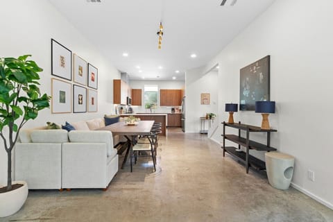 Gather around the dining table with bench and chairs, right beside the walnut kitchen for easy group meals.