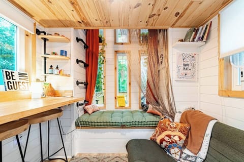 Cozy up and read a book in the 3 window reading nook... Climb the ladder on the left to get up to the twin size bed loft