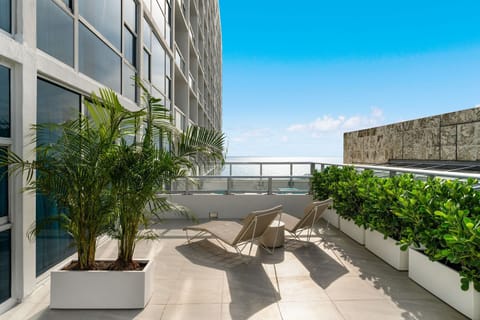 RARE Private Terrace Condo. An open-air oasis high above the city. Lush greenery and expansive skies create a serene backdrop for your morning yoga or sunset relaxation