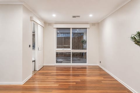 Bright, versatile room with timber floors and garden-facing window