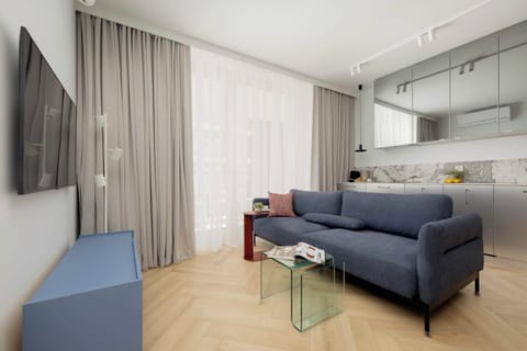 Relax in the stylish living room with a comfortable sofa and modern decor.
