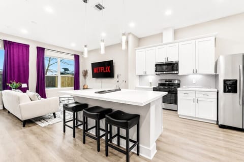 Kitchen & Living Area: Modern elegance with bright windows and entertainment-ready space!