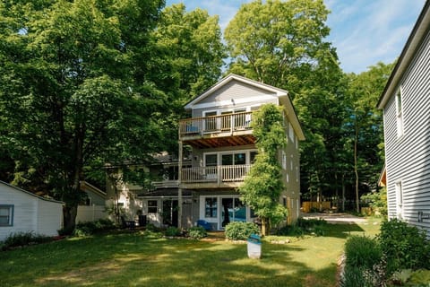 Camp Haven Heron 5 Bedroom House exterior with multi-level deck facing the trees.