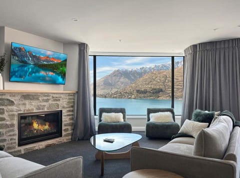 Living room with gas fireplace and lake views