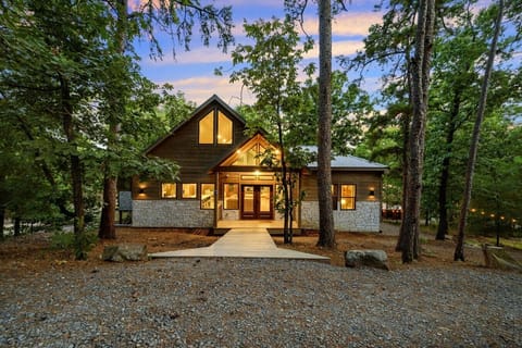 Your dream escape glows warmly through the pines, ready to welcome you home.