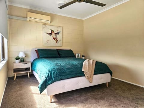 Master bed with air con and fan and wardrobe