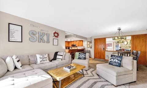 Bright and inviting living room with a plush sectional, cozy décor, and an open layout perfect for relaxing after a day on the slopes.