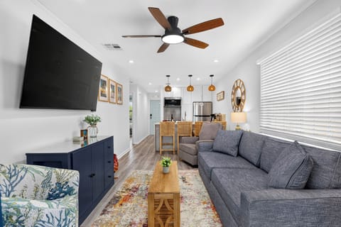 Open-concept living space highlighting seating options and pendant lighting.