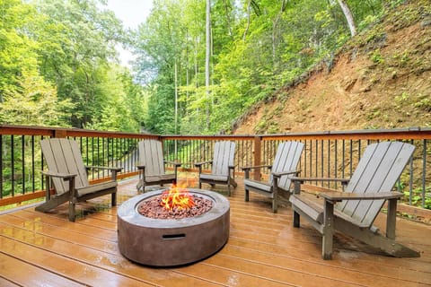 Gather around the fire on your private deck, surrounded by lush forest views and the peaceful sounds of nature.