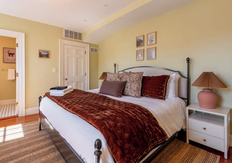 Spacious, elegant bedroom with plenty of room to unwind and coastal charm.