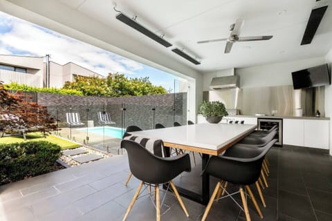 The alfresco dining area includes a gas BBQ and outdoor kitchen with a bar fridge — ideal for relaxed summer evenings.
