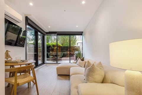 This light-filled living area features comfortable designer finishes and opens seamlessly to the courtyard.