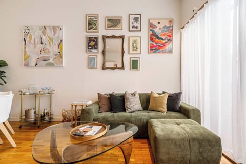 Sink into the velvet lounge beneath curated artwork, where soft natural light and warm timber floors create an inviting place to unwind after exploring the nearby Yarra River trails.