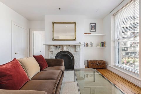 Heritage details shine through the decorative fireplace in the living area, adding old-world character and warmth to the apartment’s minimal styling.