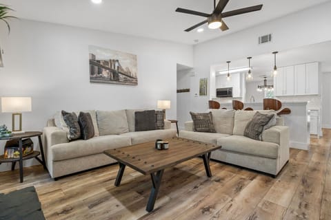 Stretch out on dual sofas facing the Smart TV, with the kitchen breakfast bar just steps away.