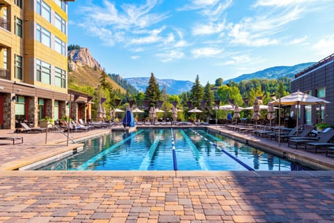 Spend sunny days by the resort-style outdoor pool, surrounded by loungers and sweeping mountain scenery.