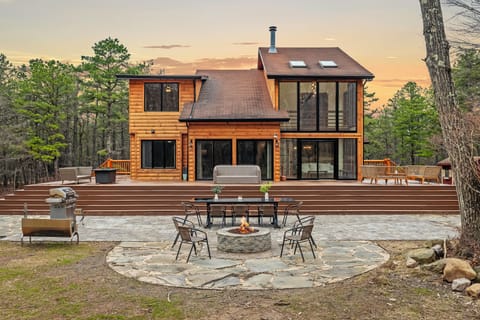 Outdoor fun spans the expansive deck and stone patio, with lounge seating and plenty of room to gather.