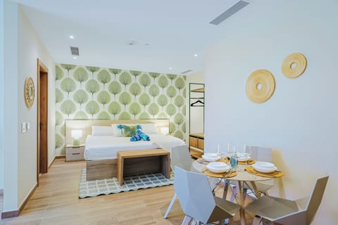 Step into your bright, modern retreat where a cozy bed meets a cheerful dining spot—perfect for morning coffee or evening meals together.