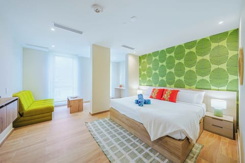 Relax in your bright, modern bedroom with cheerful tropical accents and a vibrant green leaf wall that brings nature right to your bedside.