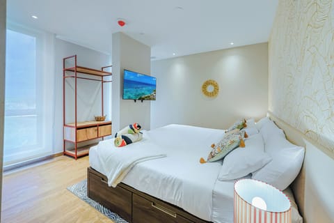 Unwind in a bright and thoughtfully designed bedroom featuring a plush king-size bed, modern furnishings, and a peaceful atmosphere for a restful night's sleep.