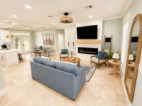 The open-concept great room flows from living to dining to kitchen — the heart of the home.