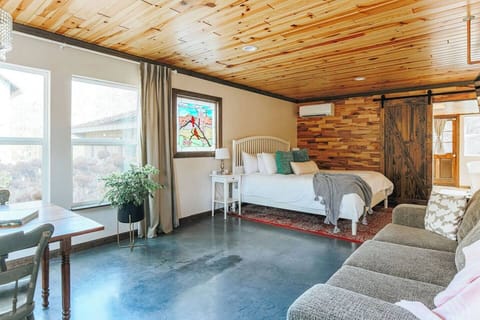 King bed with sofa-bed and large windows