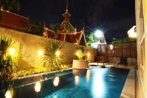 Outdoor pool, a waterfall pool, open 8:00 AM to 8:00 PM, pool umbrellas